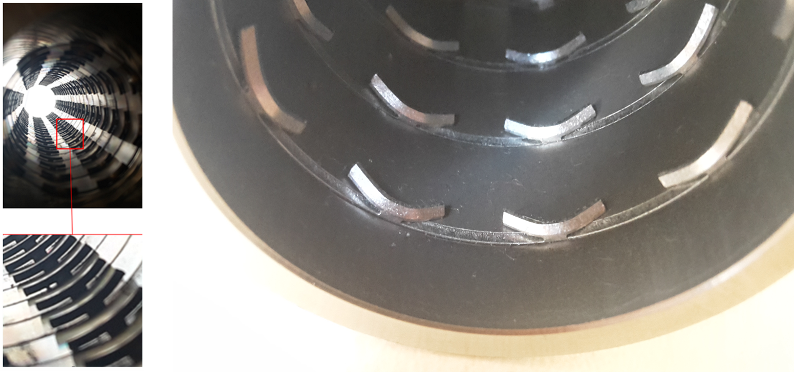 Nahaufnahme eines spiralförmigen Metallobjekts mit reflektierenden Oberflächen.